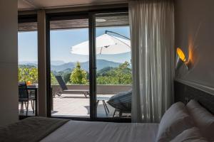 a bedroom with a bed and a view of a patio at FeelFree STAYS Basoa in Donostia-San Sebastián