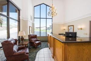 a hotel lobby with a reception desk and chairs at Branson's Best in Branson