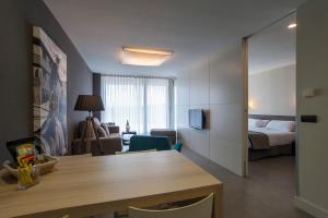 a living room with a bed and a table in a room at FeelFree STAYS Basoa in Donostia-San Sebastián
