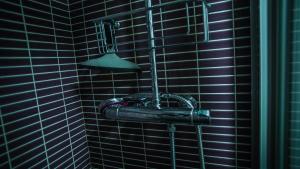 un bagno con doccia con un ombrello nero di Apartments Madrid Eliptica a Madrid