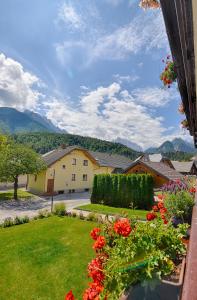 a view of a yard with flowers and a house at Apartments and Rooms Banić in Kranjska Gora
