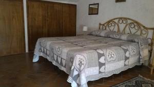a bedroom with a bed with a blanket on it at Casa Vacanze del Borgo in Sassetta