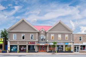a large building on a city street with shops at Micro Boutique Living Antigonish in Antigonish