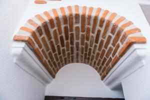 a brick staircase on a white wall at Faunele in Orosei