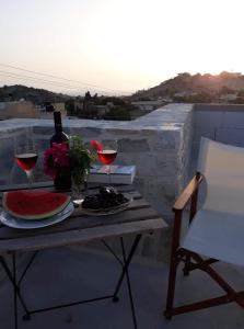 einen Tisch mit zwei Gläsern Wein auf dem Balkon in der Unterkunft Kritikies Elaia in Pitsidia