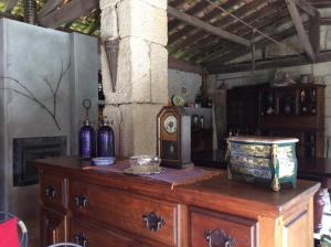 a wooden cabinet with vases on top of it at Agro-Turismo Quinta do Pendao in Santa Cruz da Trapa