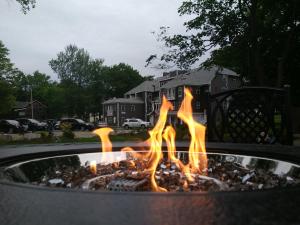 a fire pit with flames in front of a house at The Inn on Mount Desert in Bar Harbor