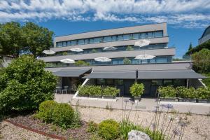 a building with umbrellas in front of it at FeelFree STAYS Basoa in Donostia-San Sebastián