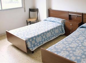 Ένα ή περισσότερα κρεβάτια σε δωμάτιο στο Apartamentos Vacacionales Caracas