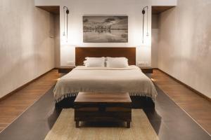 a bedroom with a large bed and a table at 976 Panangad in Cochin