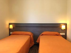 En eller flere senge i et værelse på Rentalmar Margarita