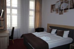 Postel nebo postele na pokoji v ubytování Hotel Elegia am Kurfürstendamm