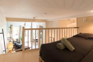 a bedroom with a bed and a balcony at Studio Jan Steen in Amsterdam