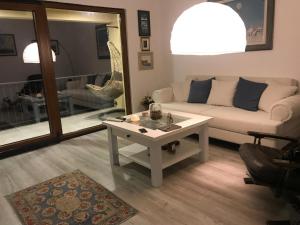 a living room with a couch and a table at Loft Infinity in Petrovac na Moru