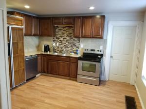 a kitchen with wooden cabinets and a stove at 514 w 23rd st in Cheyenne