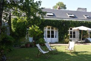 two chairs sitting in the yard of a house at Le clos des Acanthes in Vouvray