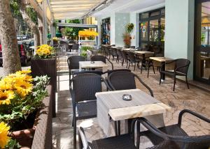 a row of tables and chairs in a restaurant at Hotel Grappoli in Rimini