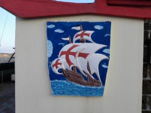a painting of a ship on the side of a building at Hotel Grappoli in Rimini