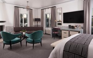 a hotel room with a bed and a table and chairs at Hotel Californian in Santa Barbara