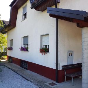 a building with two windows with flower boxes on it at Pri Šimenc in Mengeš