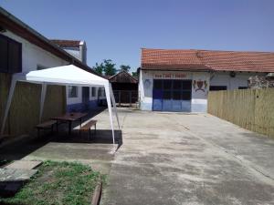 a white tent in front of a building at Guest house Ćane Smestaj in Bela Crkva