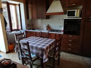 a kitchen with a table and a stove top oven at Campino in Stresa