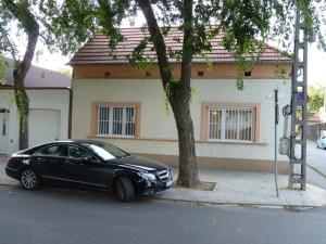 a black car parked in front of a house at Eper Apartman in Debrecen
