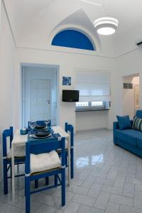 a living room with a blue table and chairs at Capri Blue in Capri