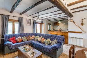 a living room with a blue couch and a table at Casa Josefina in Gea de Albarracín