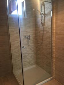 a shower stall with a glass door with a shower at Mediterranean Apartment With Great Sea View in Marina