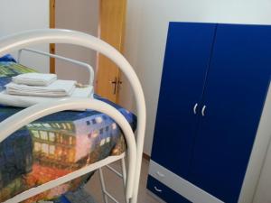 a small blue cabinet next to a bed and a blue drawer at Villa Fiorella in Sciacca