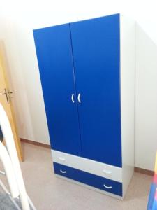 a blue cabinet sitting in the corner of a room at Villa Fiorella in Sciacca