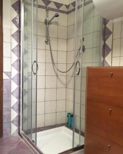 una doccia con porta in vetro in bagno di Casa Aurora a Dorgali