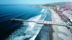 an aerial view of a beach and the ocean at Pacific Terrace Hotel in San Diego