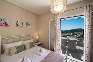 a bedroom with a bed and a large window at Villa Amolena in Kariá