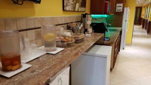a kitchen with a counter with drinks on it at Chelsea Pines Inn in New York