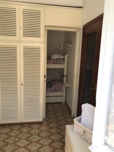 a bedroom with white closet doors and a bed at casa fiorella in San Bernardino