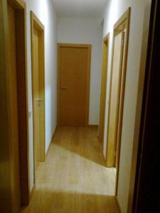 an empty hallway with two doors and a hallwayngth at Portela - APARTAMENTO in Viana do Castelo
