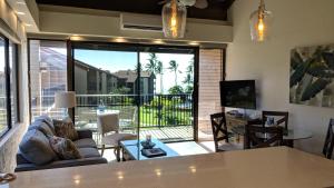 a living room with a couch and a table at Papakea #H401 in Lahaina