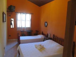 Ένα ή περισσότερα κρεβάτια σε δωμάτιο στο Pousada Lugar Comum