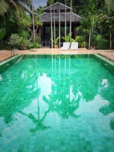 a swimming pool with green tiles in a resort at Mae Nai Gardens in Ban Mae Mae