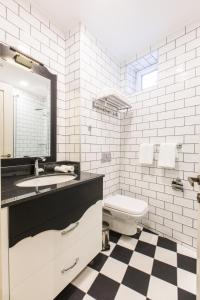 a bathroom with a toilet, sink, and mirror at Hotel Khokhobi Old Tbilisi in Tbilisi City
