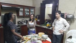 a group of people standing in a kitchen at Resident View Homestay in Kandy
