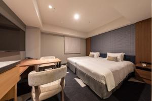 a hotel room with a bed and a desk at Tokyu Stay Sapporo Odori in Sapporo
