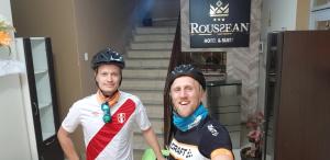 two men wearing helmets standing in front of stairs at Hotel Roussean in San Vicente de Cañete