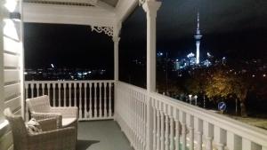 a balcony with a view of the city at night at Franklin38 in Auckland