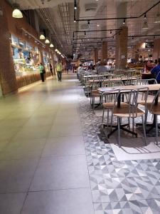 a dining room with tables and chairs in a building at Smart Residence@Muengthongthani in Nonthaburi