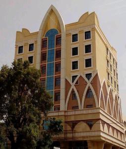 a large building with a large window at Capital Hotel Djibouti in Djibouti