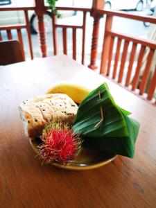 a plate of food with a banana on a table at Kraisaeng Place in Phitsanulok