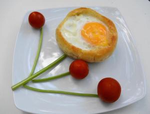 a white plate with an egg and tomatoes on it at Residenza Dutzu-Boutique Hotel in Brăila